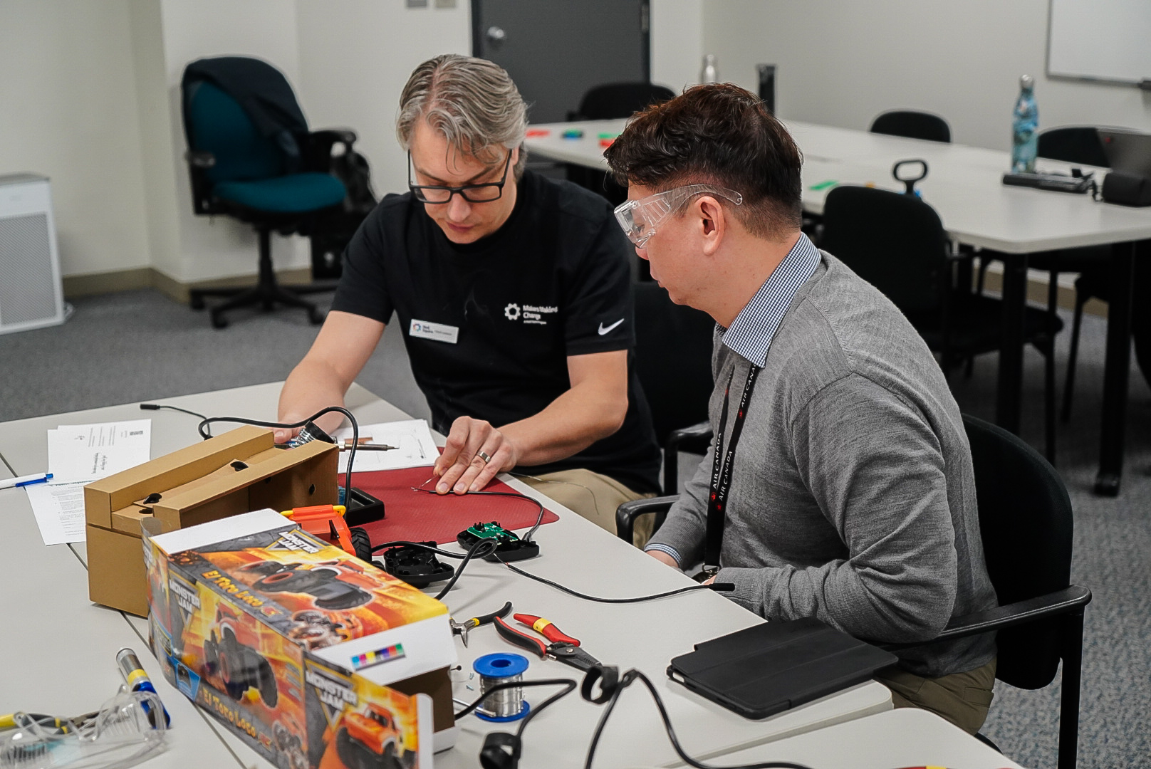 Chad helps an Air Canada staff member adapt a toy.