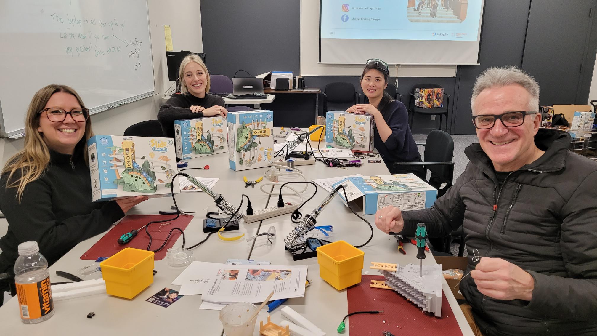 Air Canada staff hold up the toys they are working on.