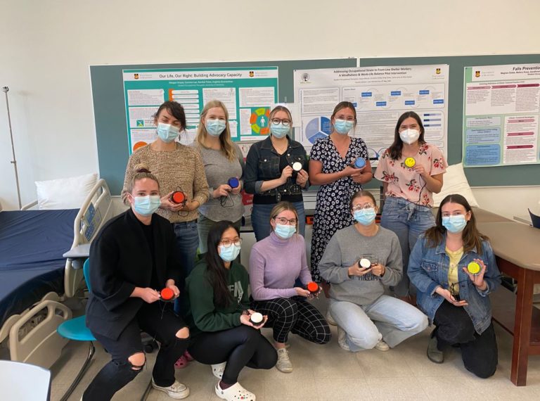 A group of participants holding their built devices in a classroom.