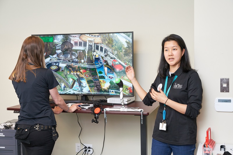 MMC staff Kristina and Zee showcasing our adaptive gaming setup.