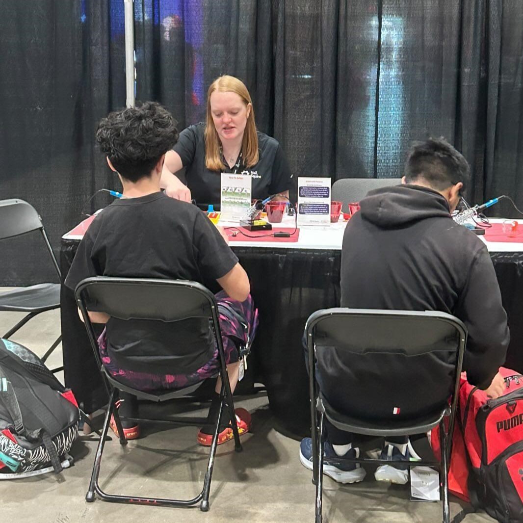 Josie helping students build their battery interrupters.