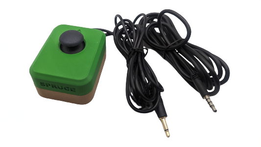 A green and black rectangular joystick with 2 black cables