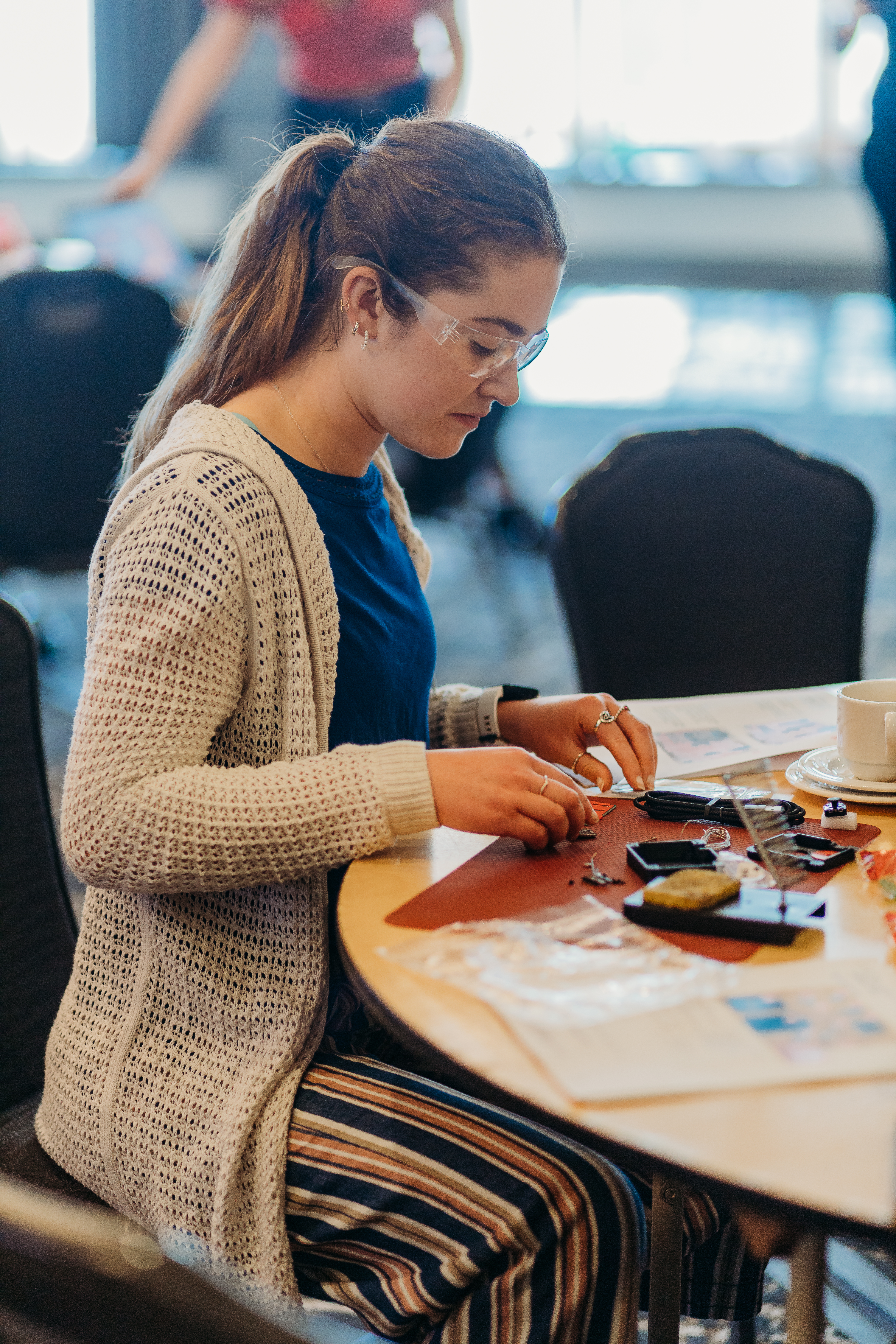 A volunteer building an assistive device.