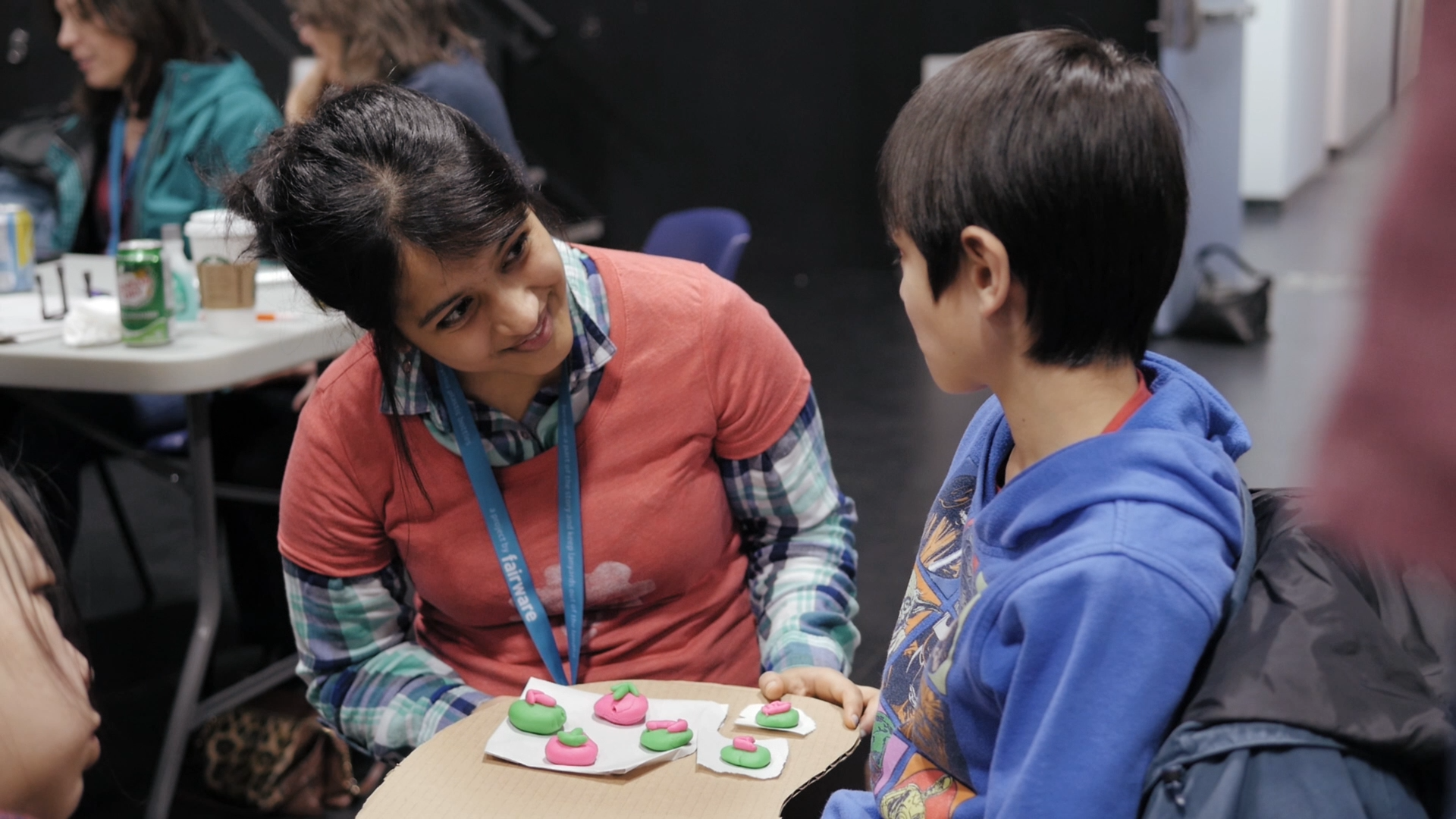 Rashmi working with Timothy, a 10 year old boy with a disability, on a controller that he can use at the Access Makeathon.