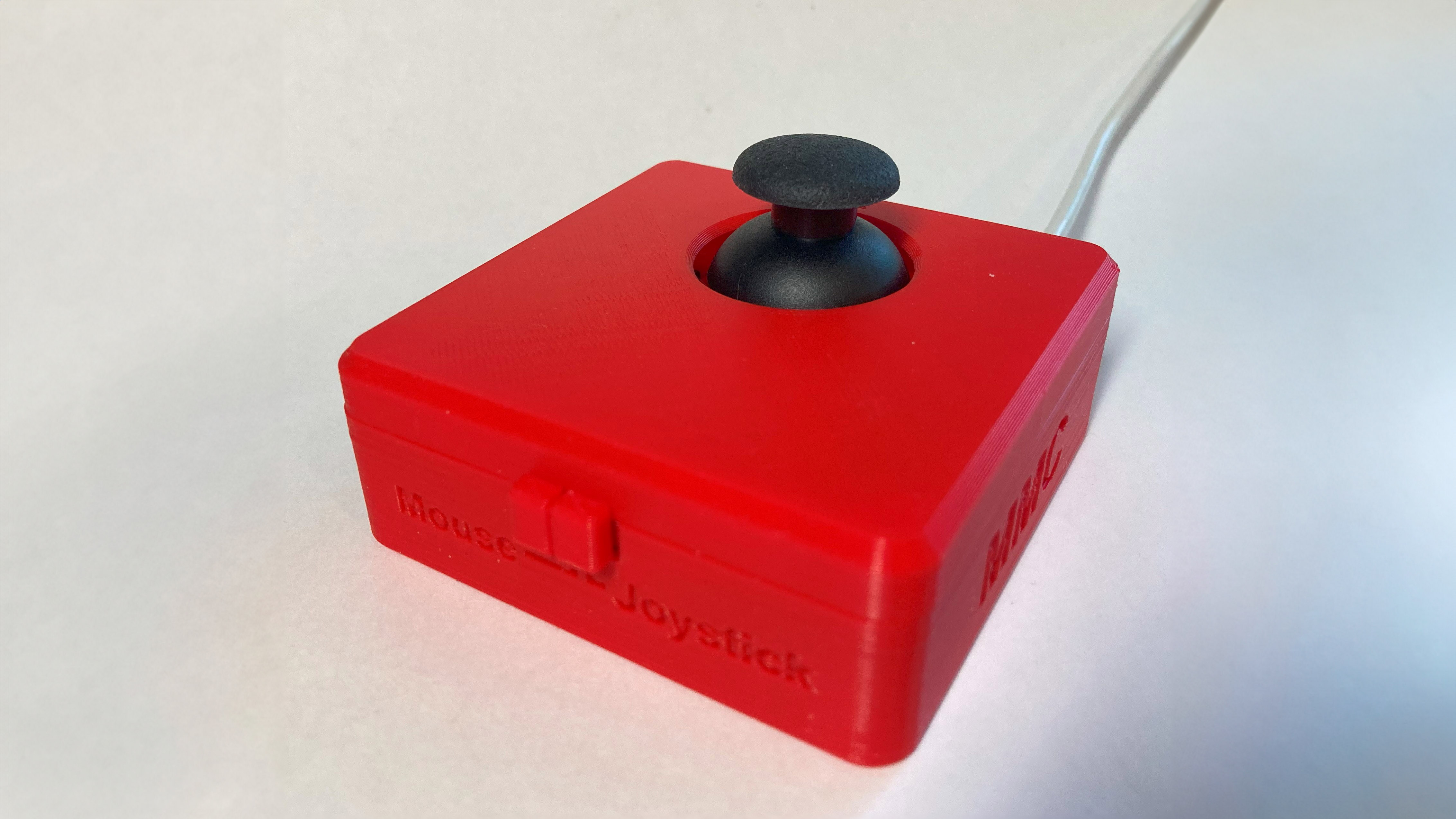 A red rectangular joystick with a black thumbstick.
