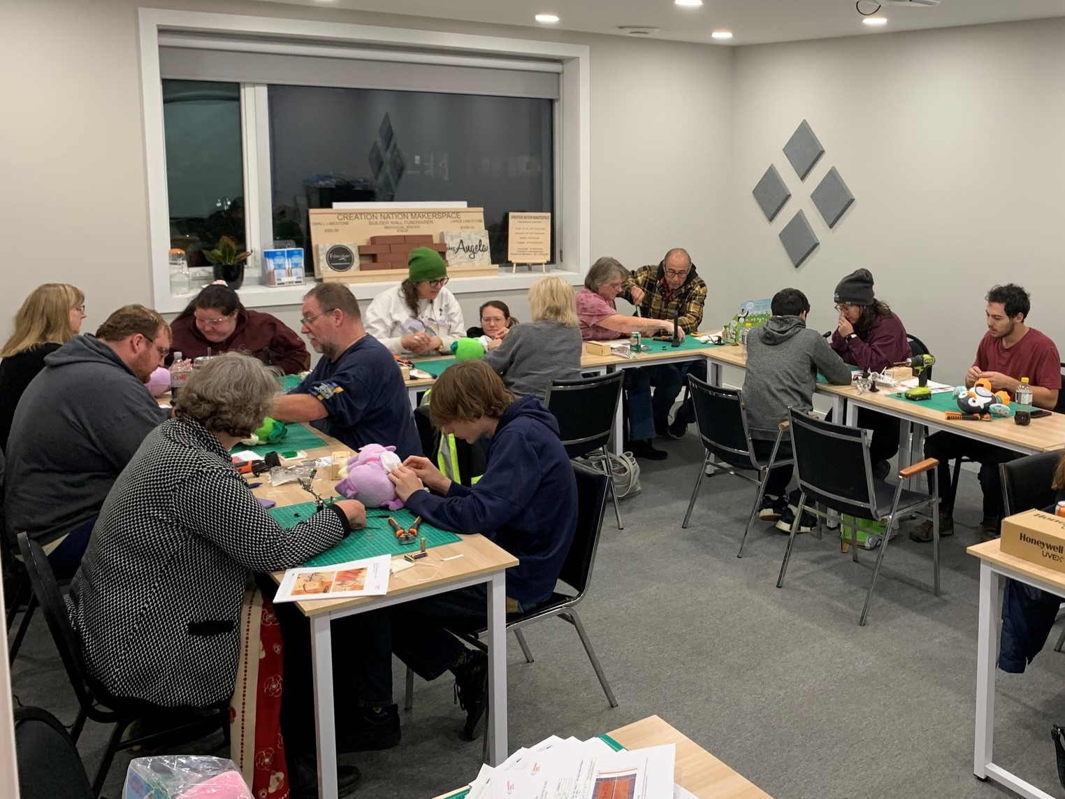 A room of volunteers toys at the Creation Nation Makerspace