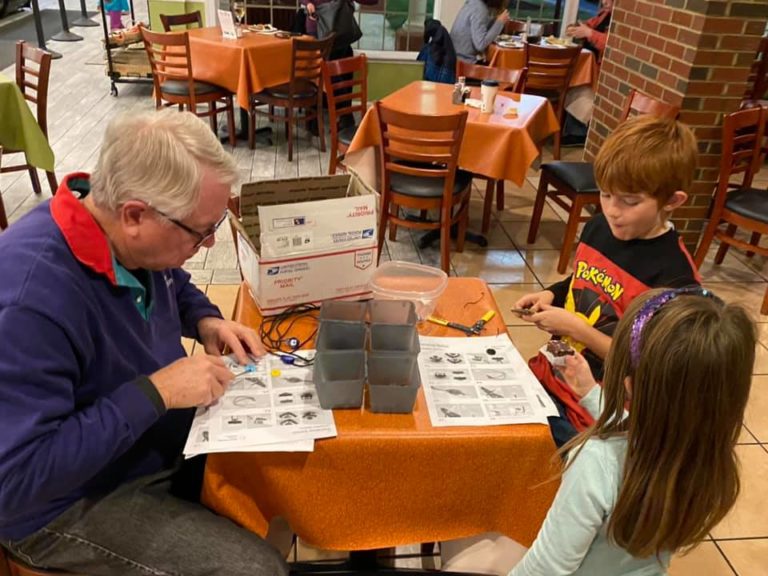 Ryan Hall participants making assistive devices on a table.