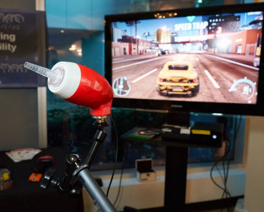 A red and white LipSync being used to game.