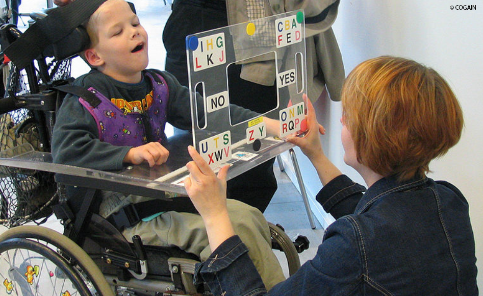 A child using a Eye Gaze Board with Letters and Yes and No on it
