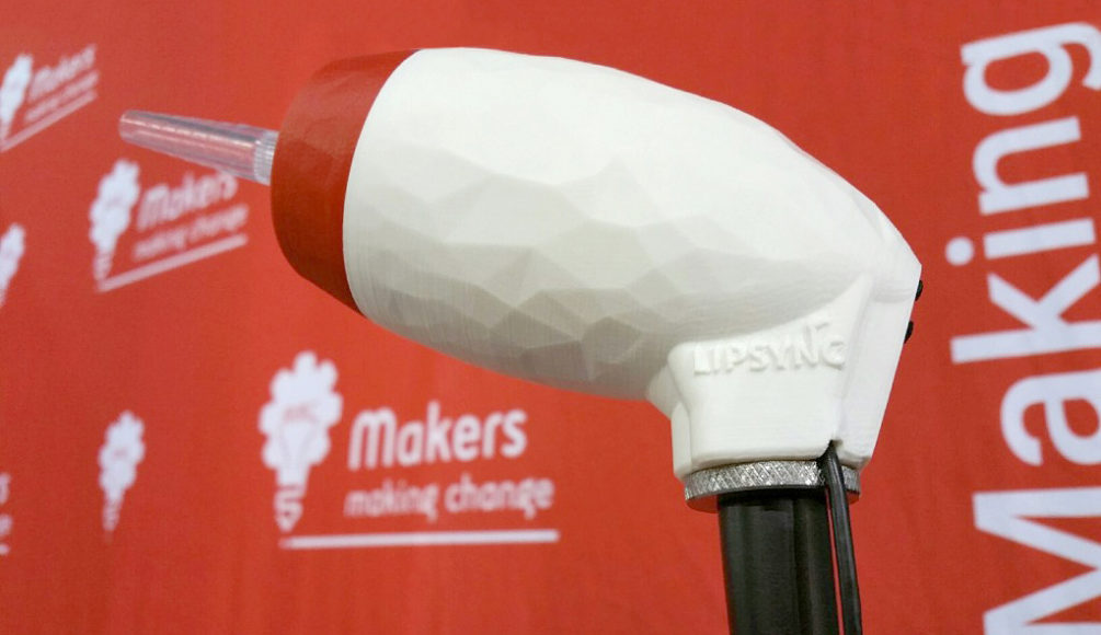 The LipSync Classic in front of a backdrop with the old Makers Making Change logo.