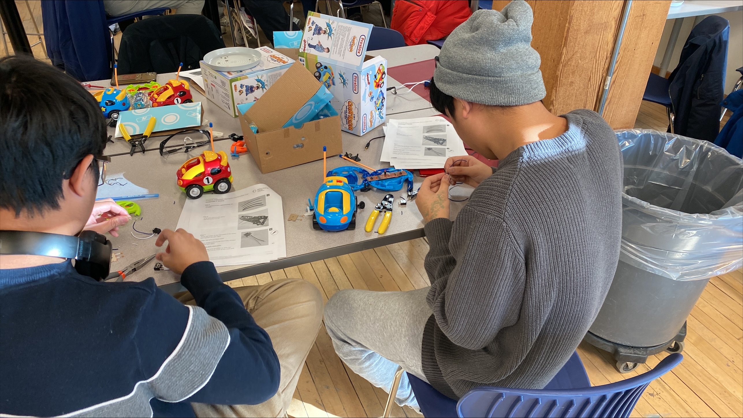 Two students adapting toy cars