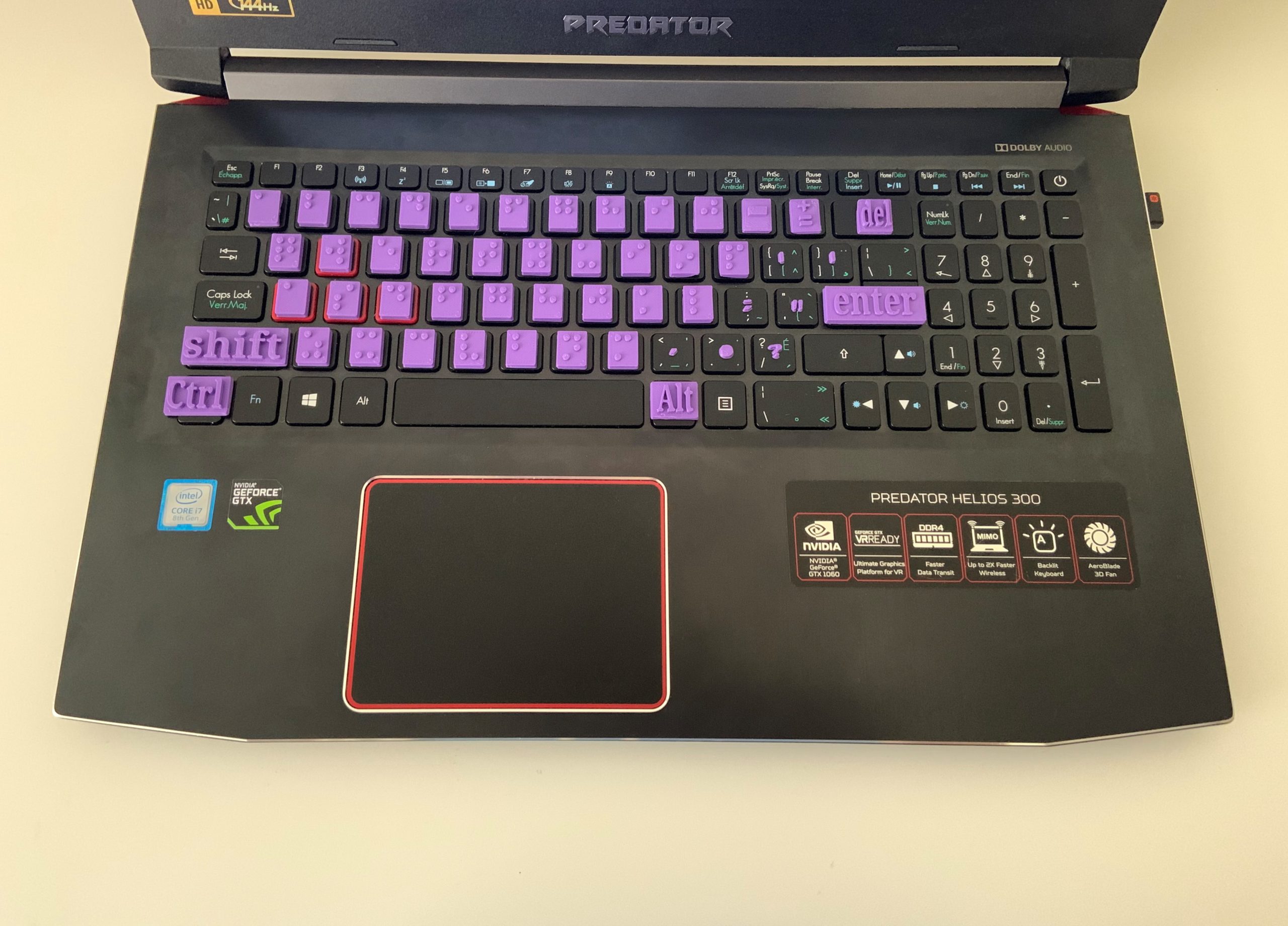 Image of keyboard with 3d printed Braille tiles attached