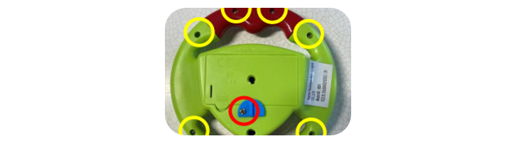 The remote control car flipped over to show where the screws are.