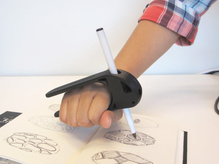 A hand using a black Palm Pen Holder.