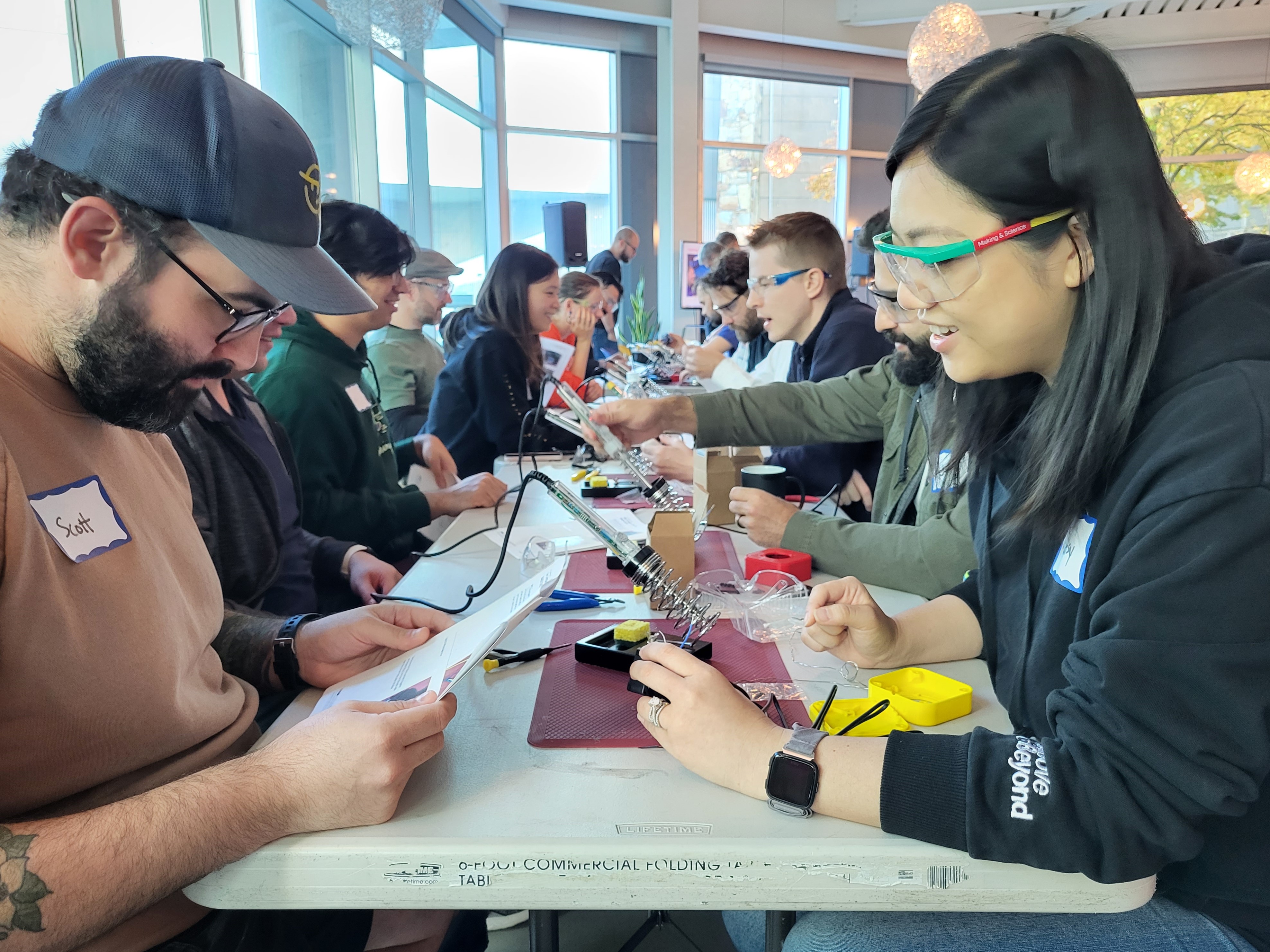A male and female EA employee working together to assemble a 3d printed joystick