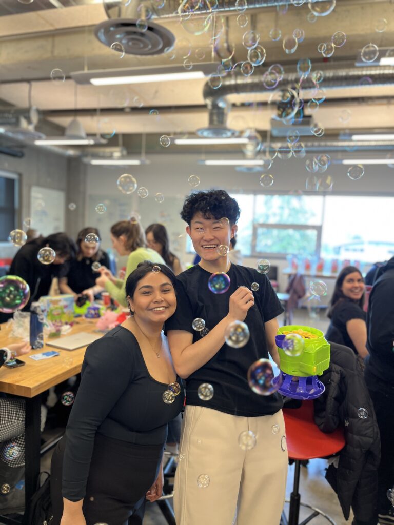 Participants at a UBC Enable build, holding a switch-adapted bubble blower.