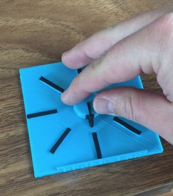 A 3D printed tactile model with a hand rotating to one of 6 angles