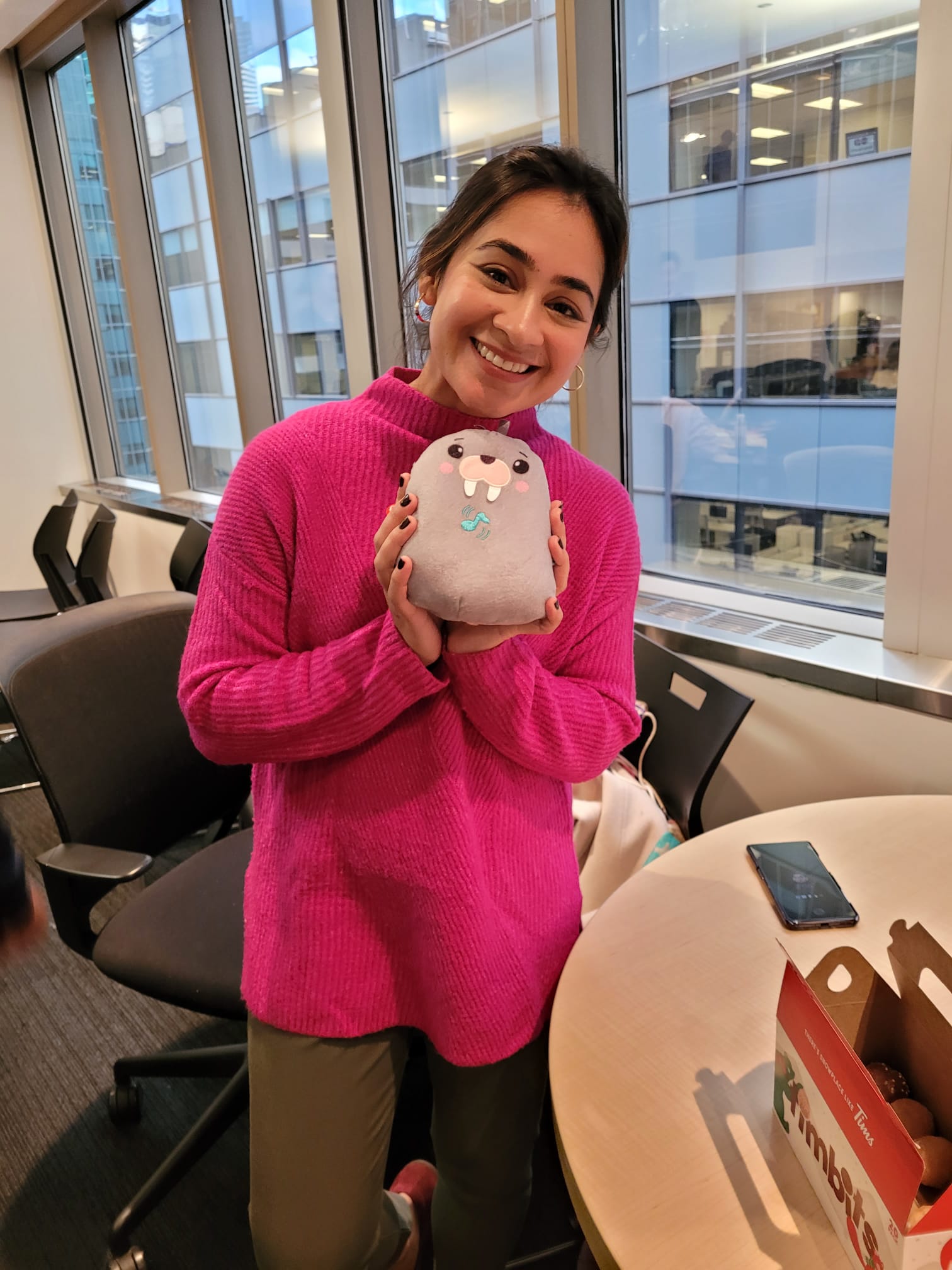 A woman holding an adapted toy walrus
