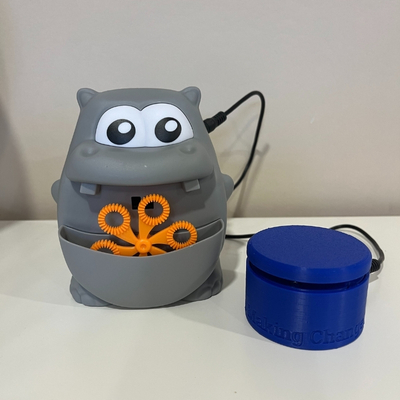 An interact switch plugged into a small bubble machine shaped as a hippo