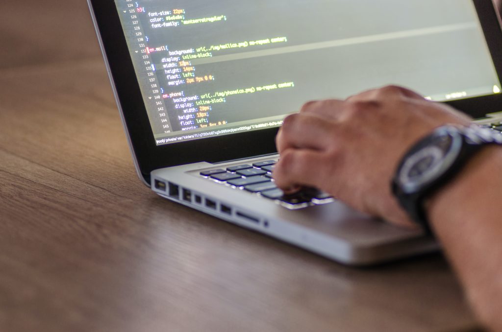 A laptop screen displaying code.