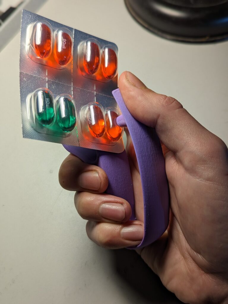 A purple Blister Pack Opener being user to open pills.