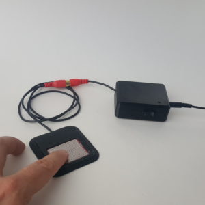 Picture of resistive touch switch with a finger touching the resistive pad