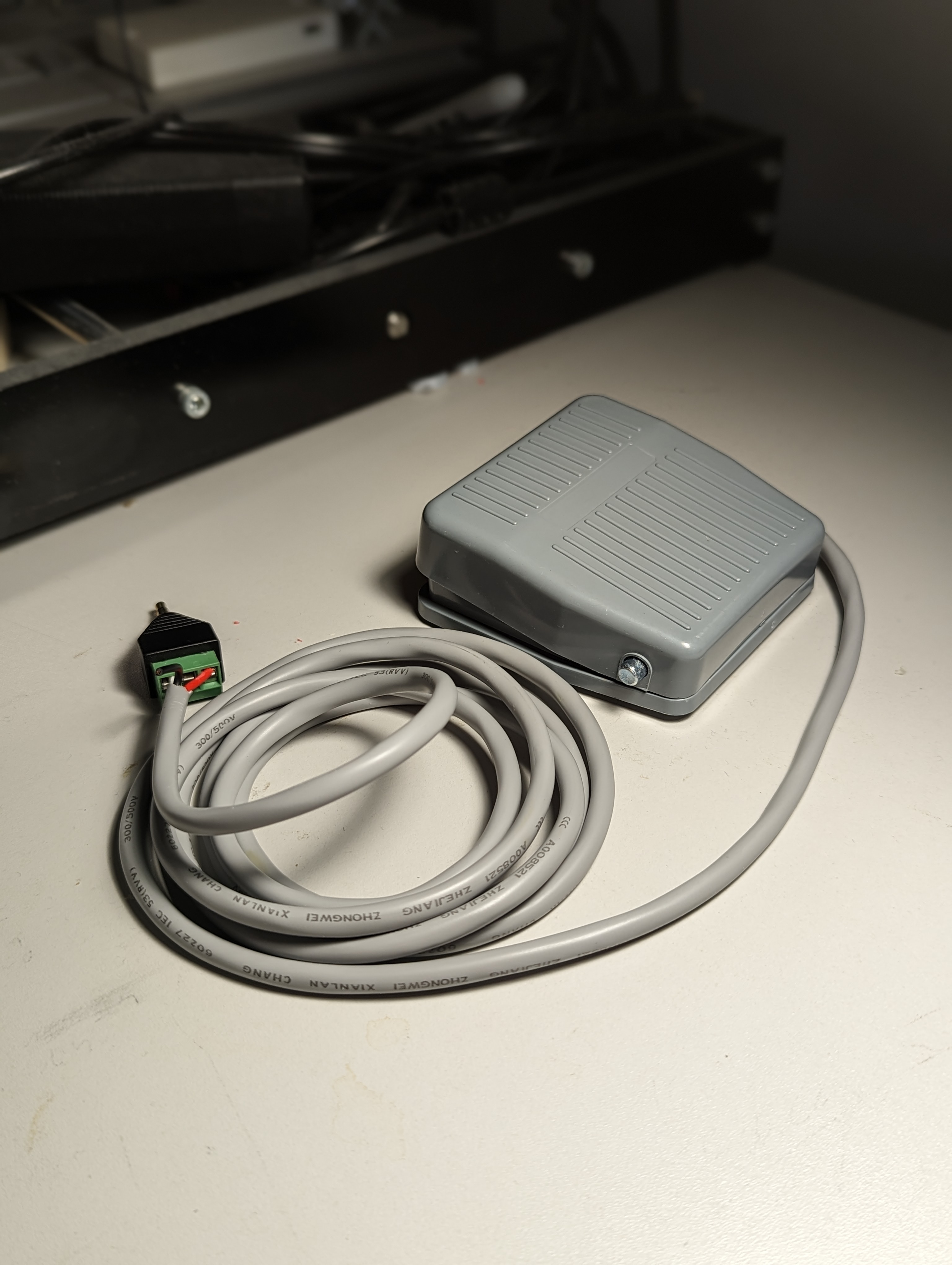 Foot pedal switch with coiled wire sitting on a table