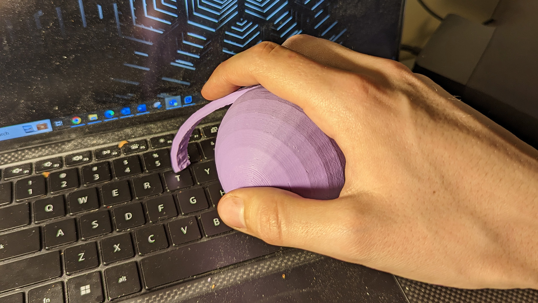 Typing with the arthritis typing aid on a black computer keyboard