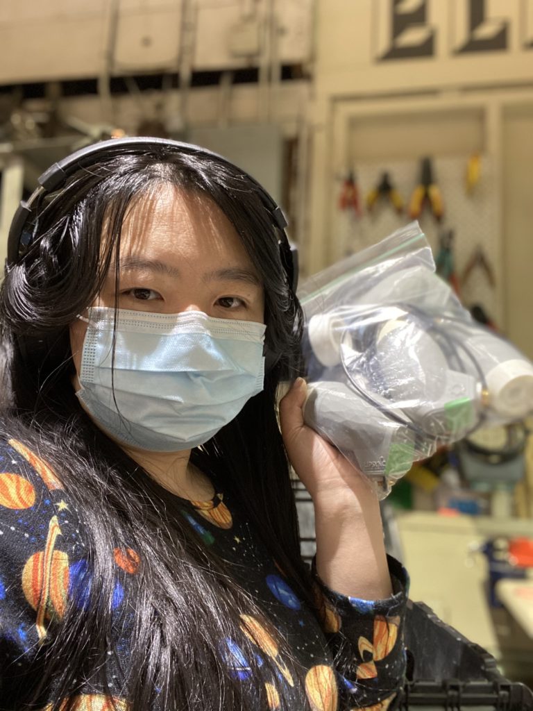 Mimi, a maker, holding electrical components.