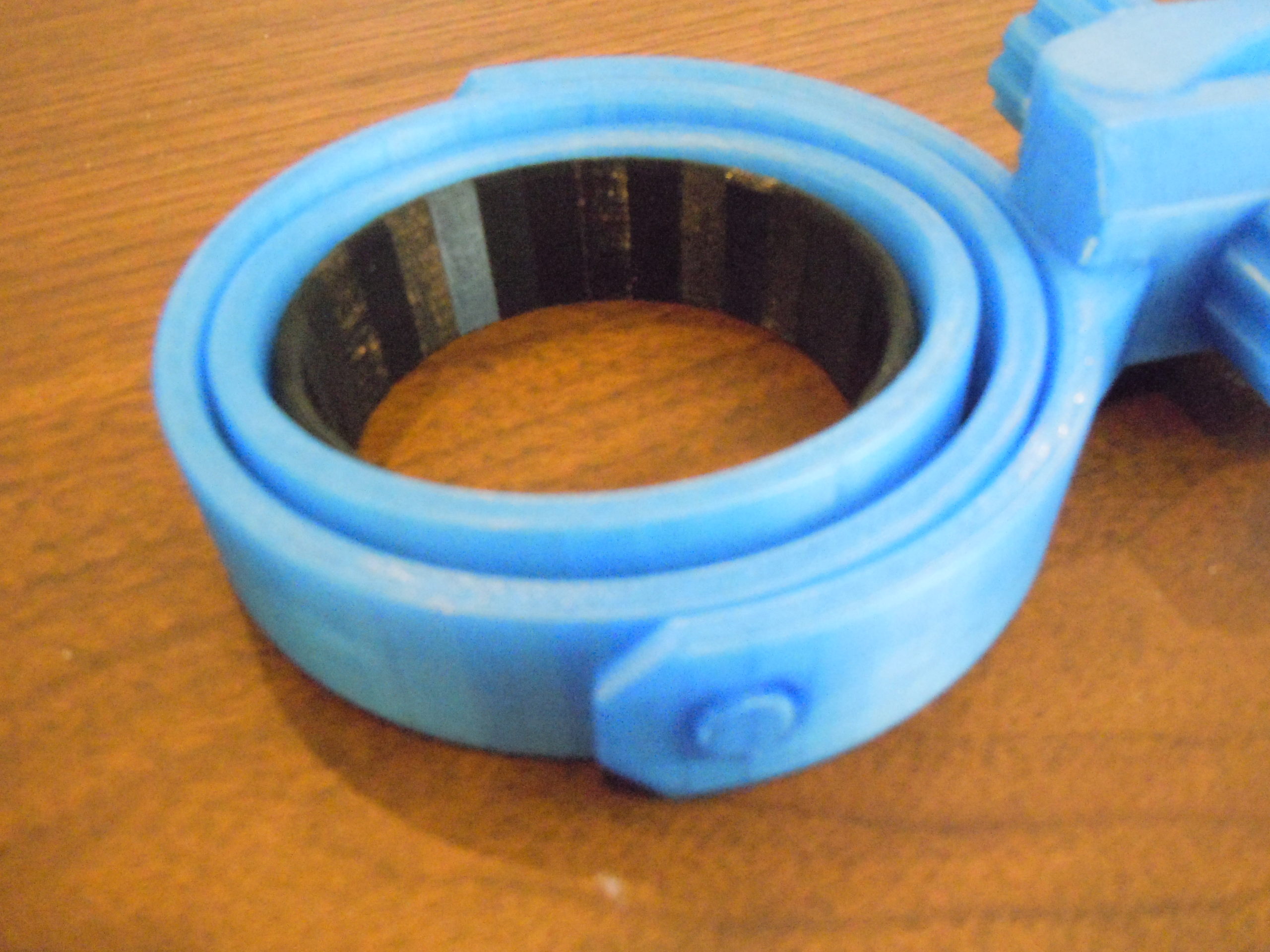 A white 3d printed Universal Travel Coffee Gimbal with the Cup Holder Resizing Ring inserted.
