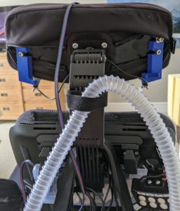 Photo of powerchair headrest with head button mounts attached