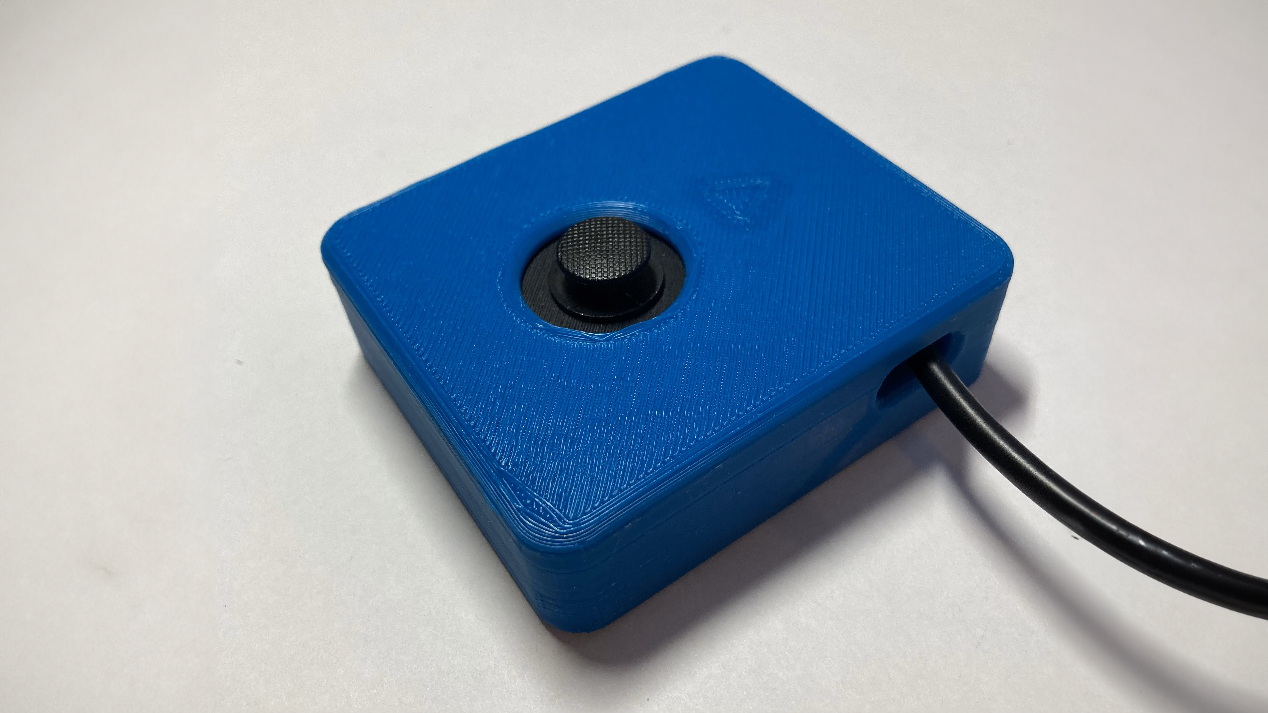 A blue square joystick with a small thumbstick