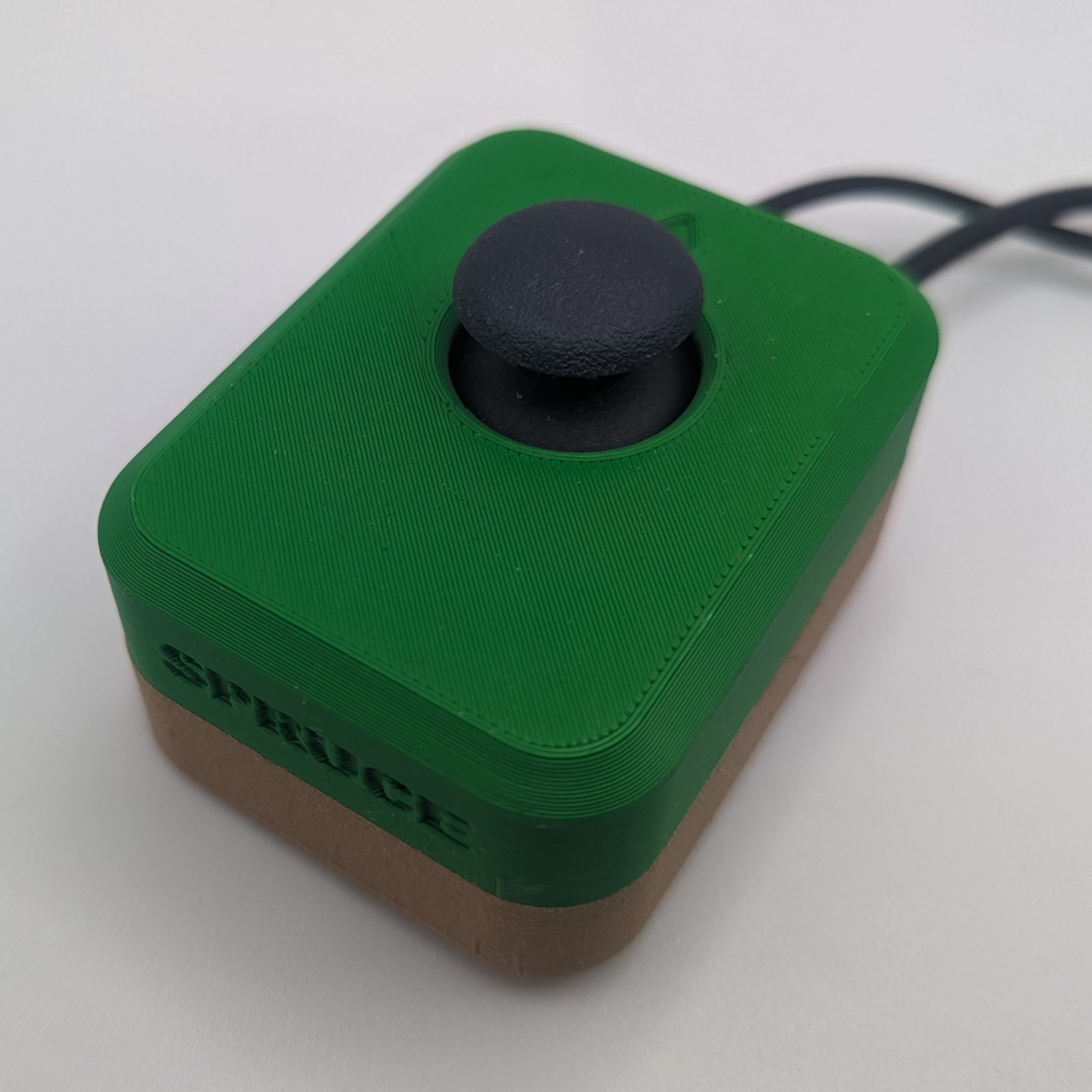 A Spruce Mini Joystick with a green top and a brown bottom.