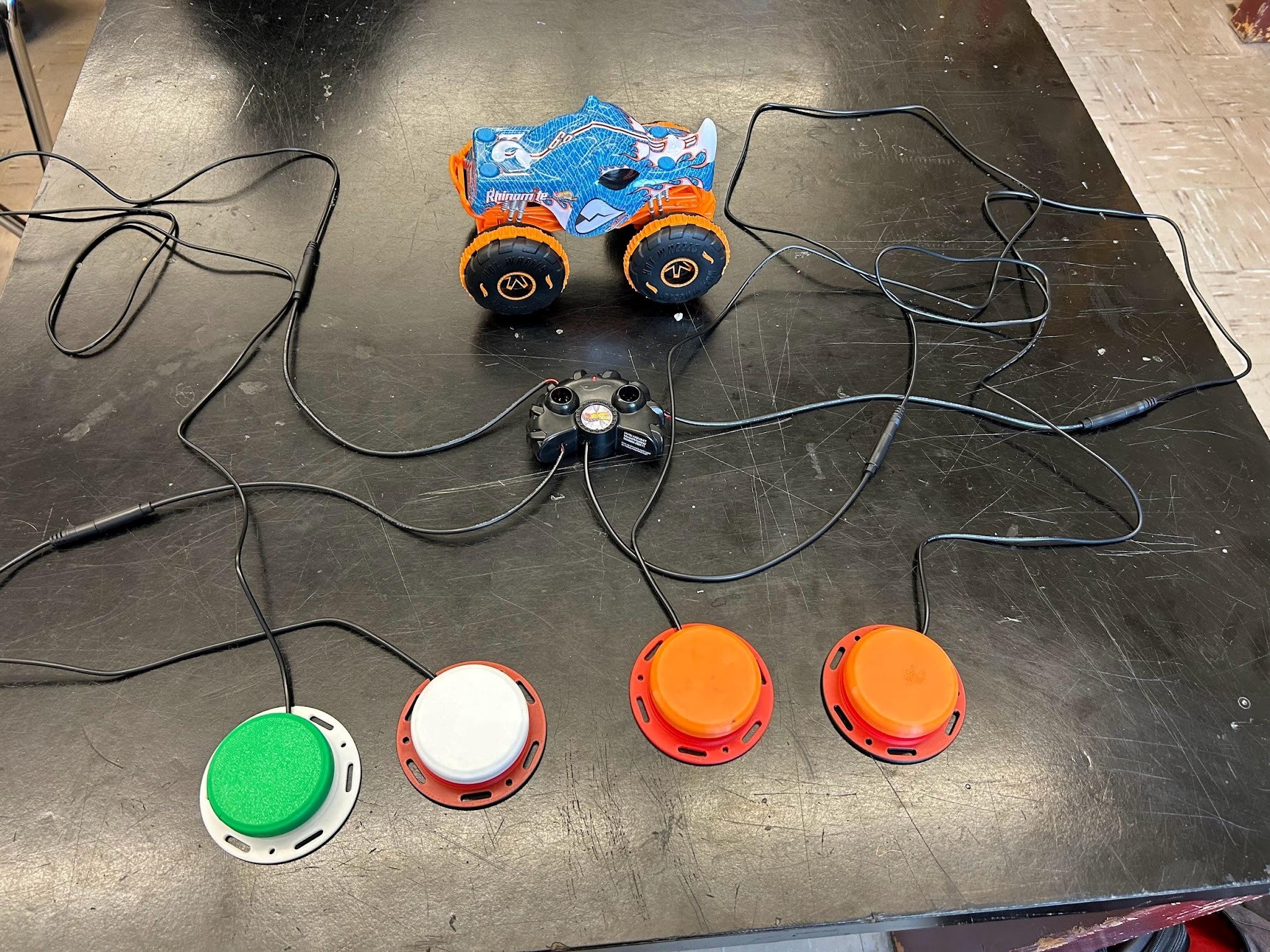 A RC monster truck controlled by a controller that has been switch adapted.