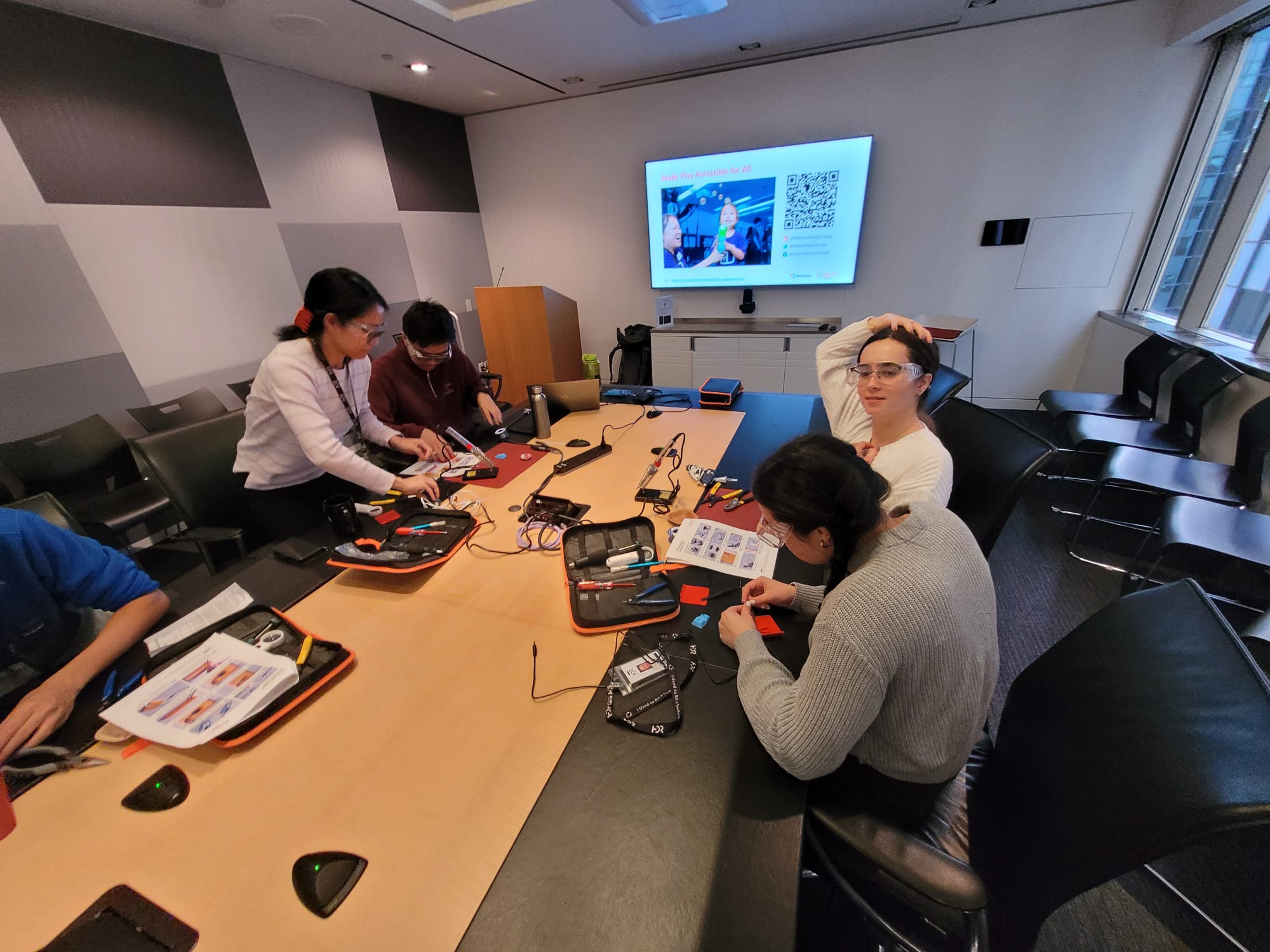 Volunteers in a room building switches.