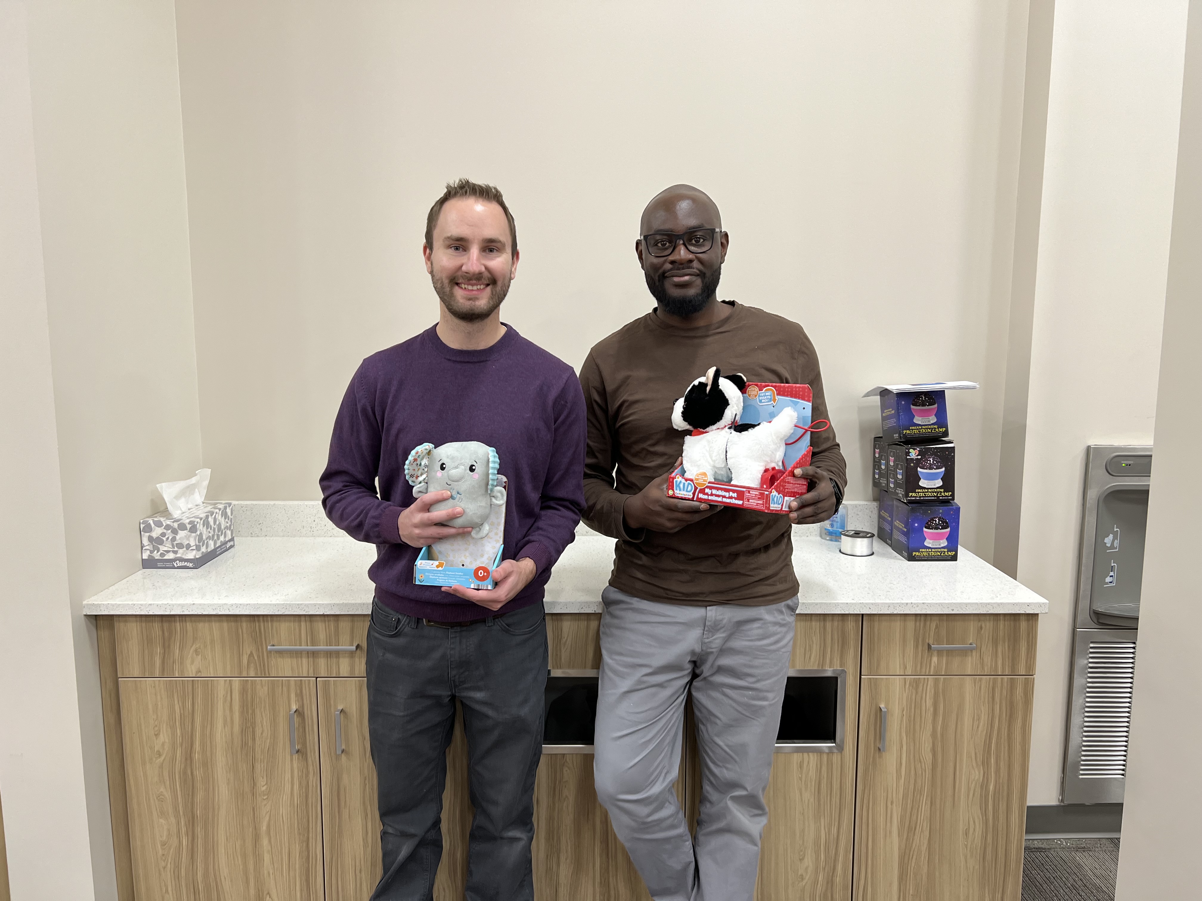 wo SaskPower employees with adapted toys