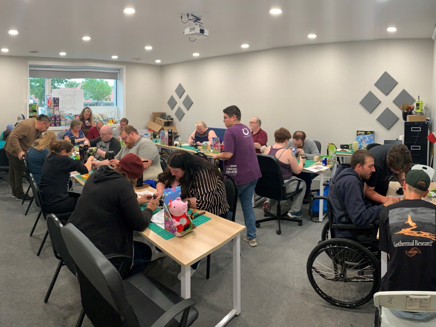 A room of volunteers toys at the Creation Nation Makerspace
