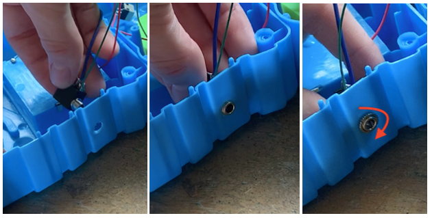 A hand installing an internal jack to a toy.