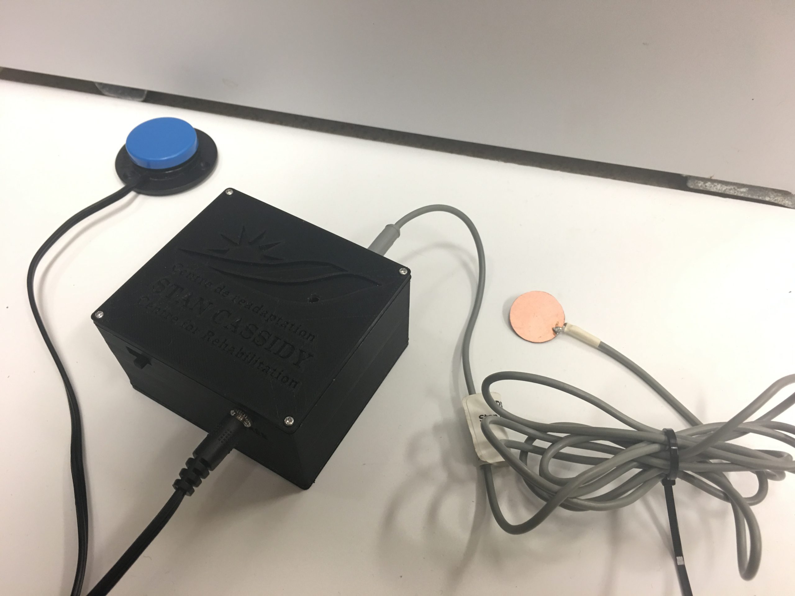 Picture of the 3D printed Switch Modifier Enclosure with an assistive switch plugged in.