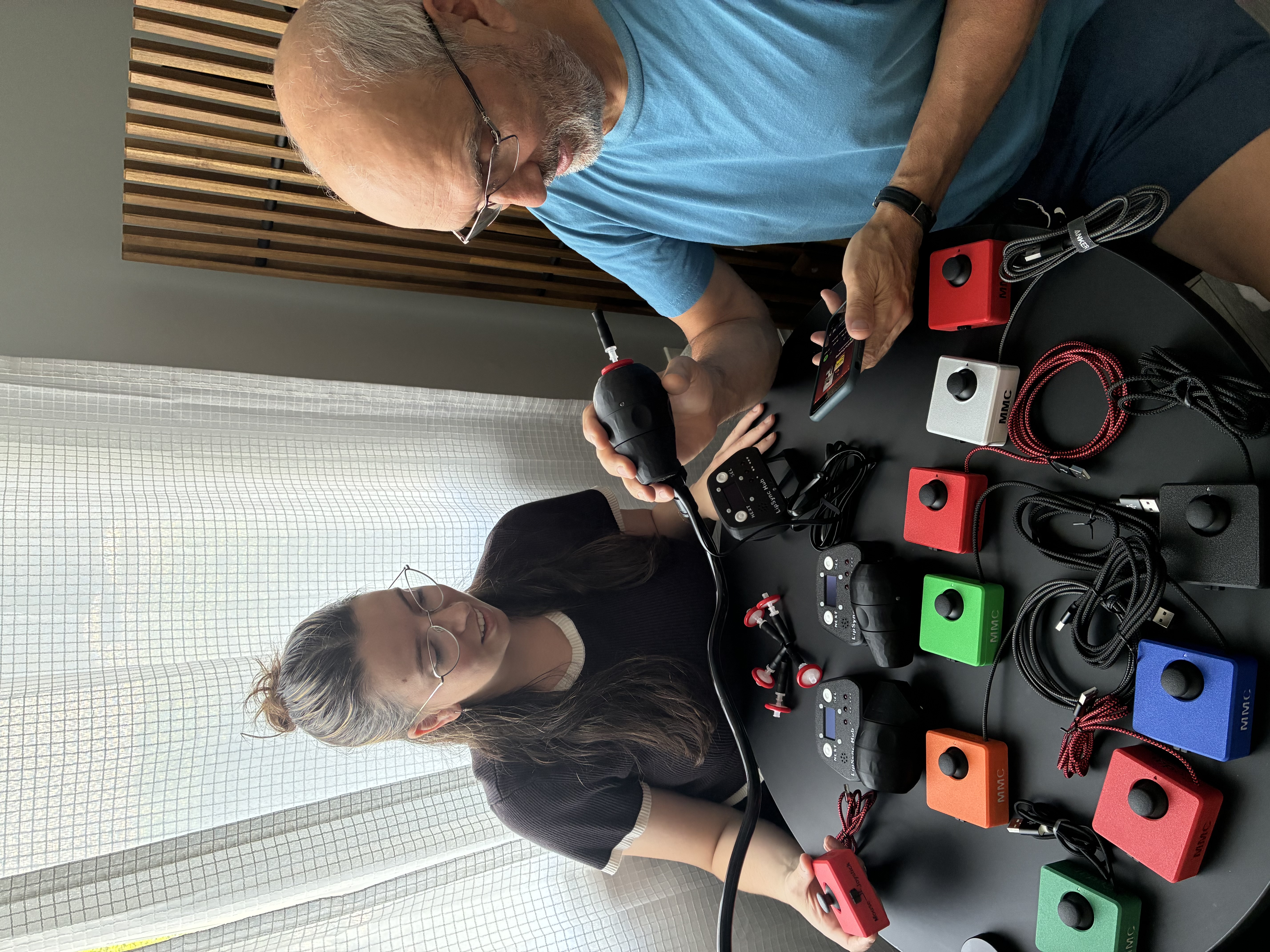 Alyssa and Jody testing the devices they've built, including many Cedar joysticks and a LipSync.
