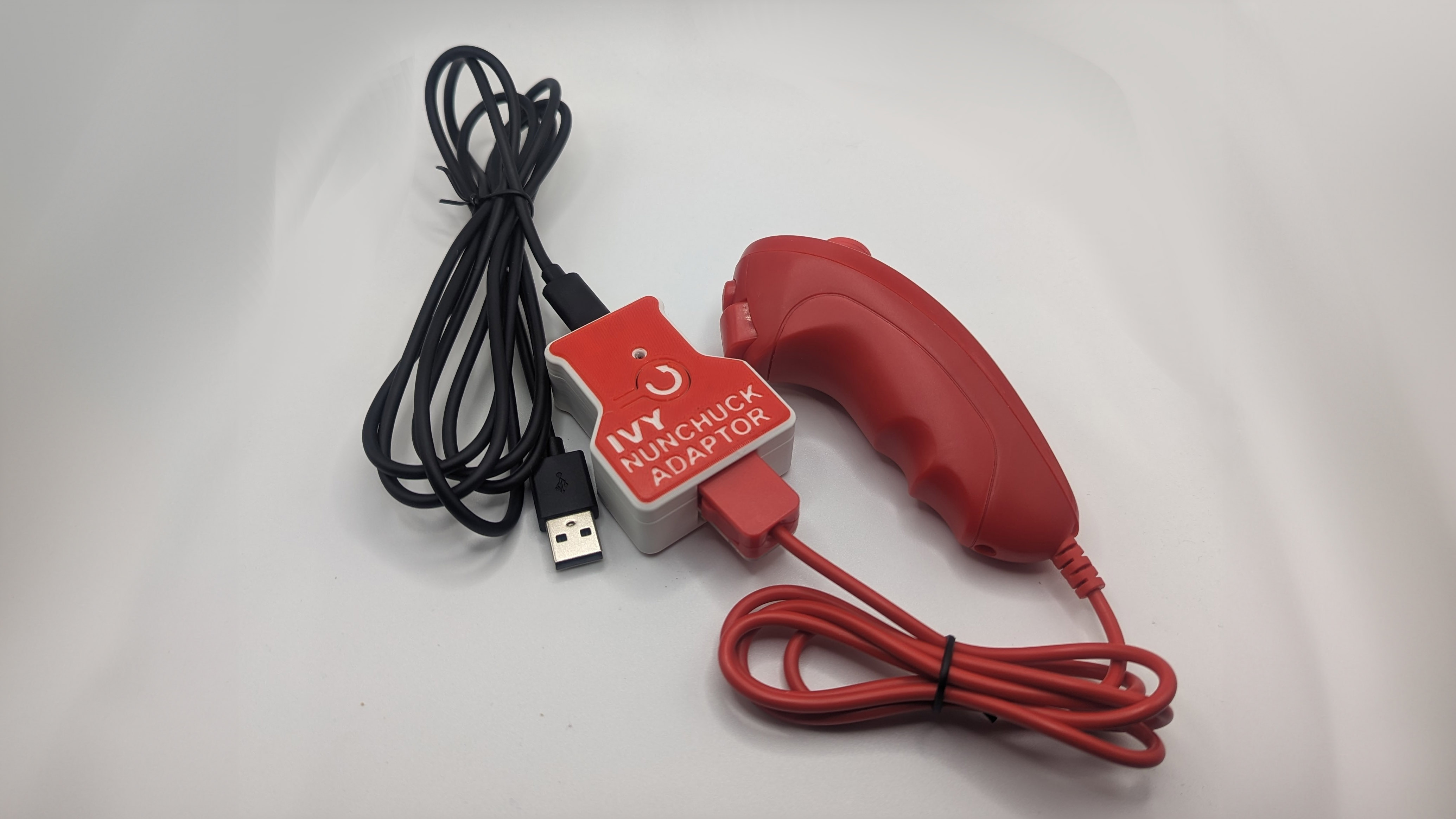A red nunchuck joystick plugged into a ivy nunchuck adapter