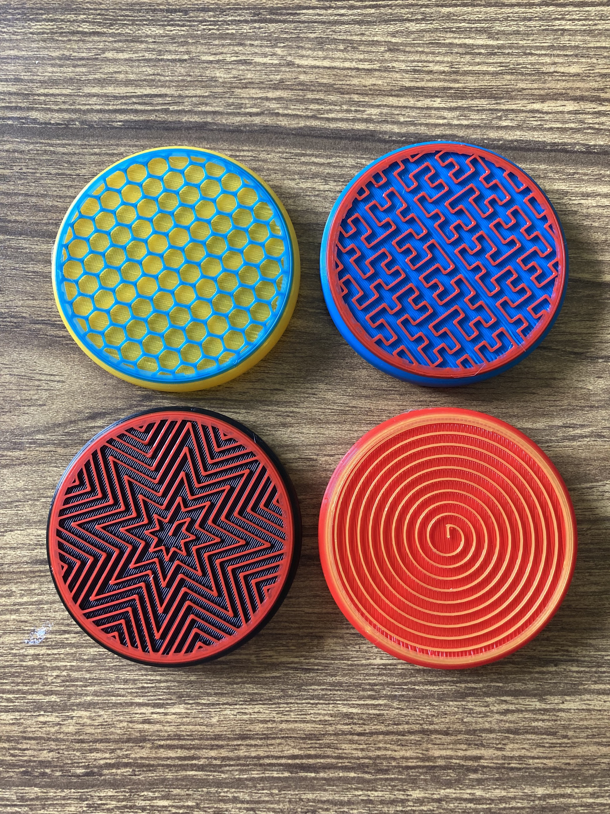 Four different assistive switch toppers in different colours and patterns.