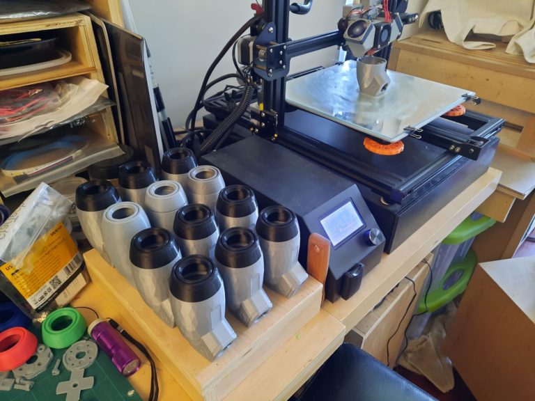 An assortment of LipSyncs beside a 3D printer.