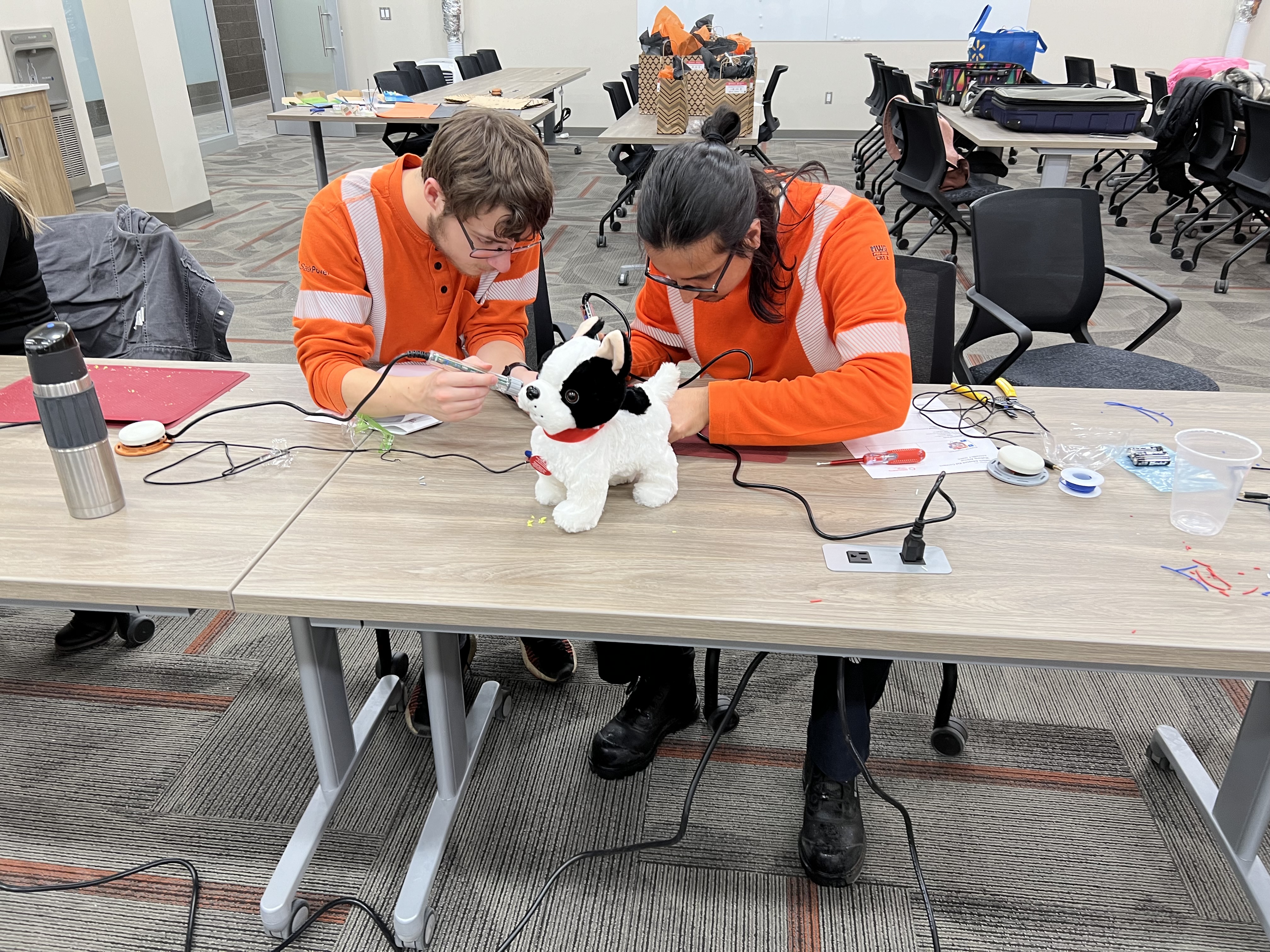 Two SaskPower employees adapting toys