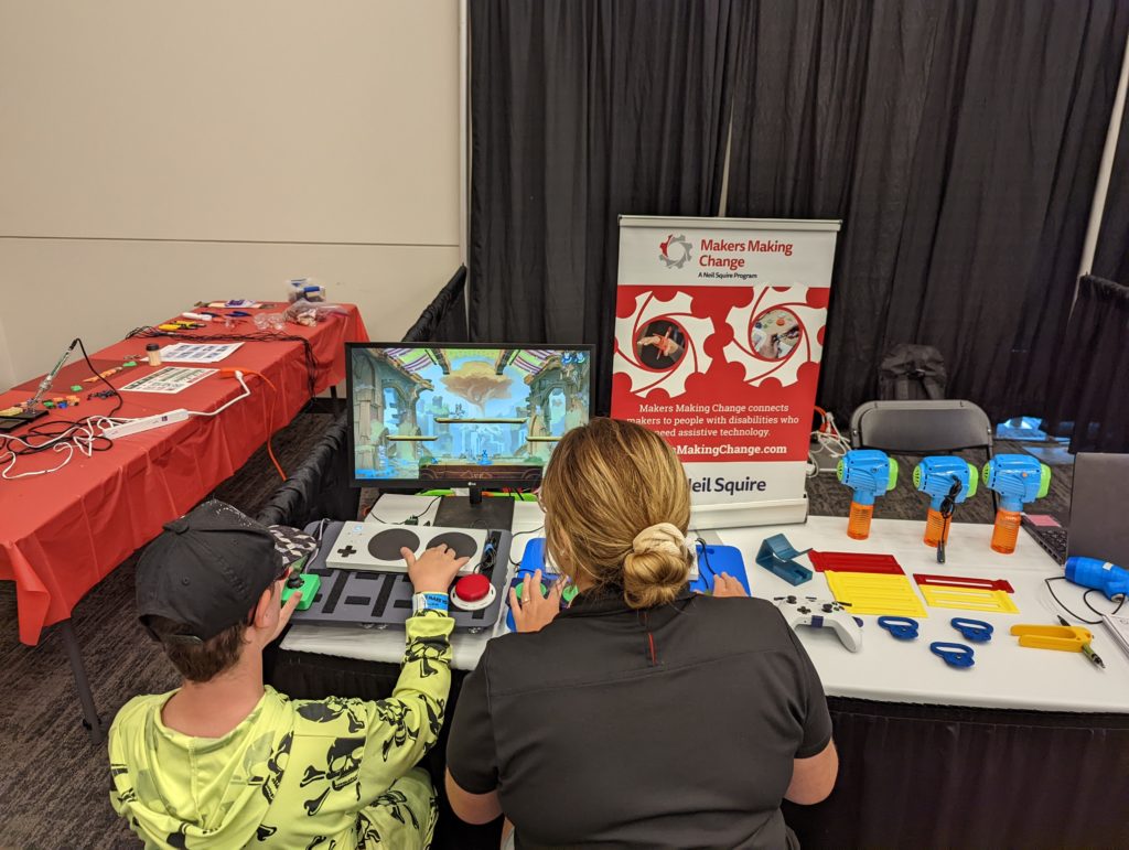 Two attendees using switches to game at our booth.