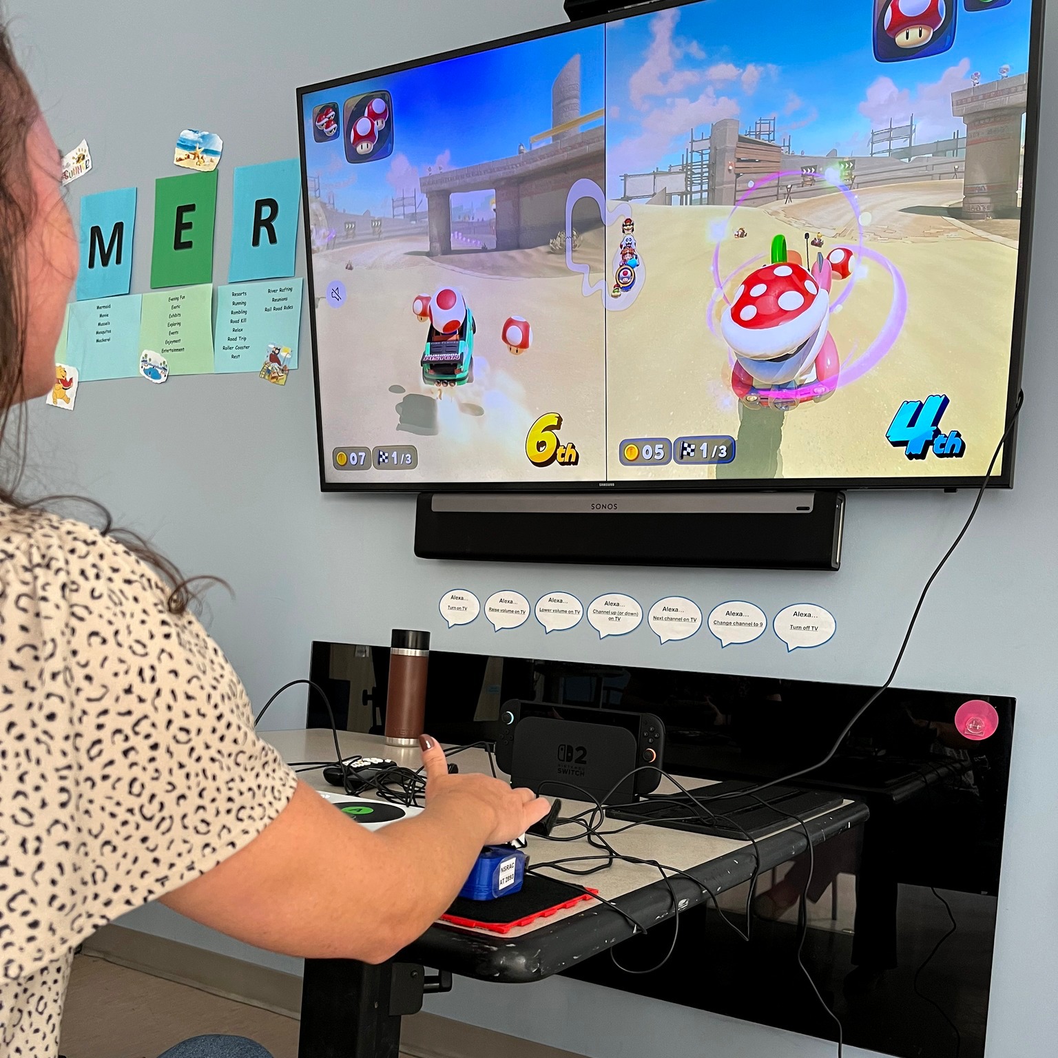 A person plays Mario Kart using an adaptive gaming set-up.