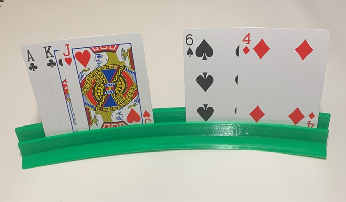 Green 3D printed card holder holding an ace, king, jack, 6 of spades, and 4 of diamond playing cards.