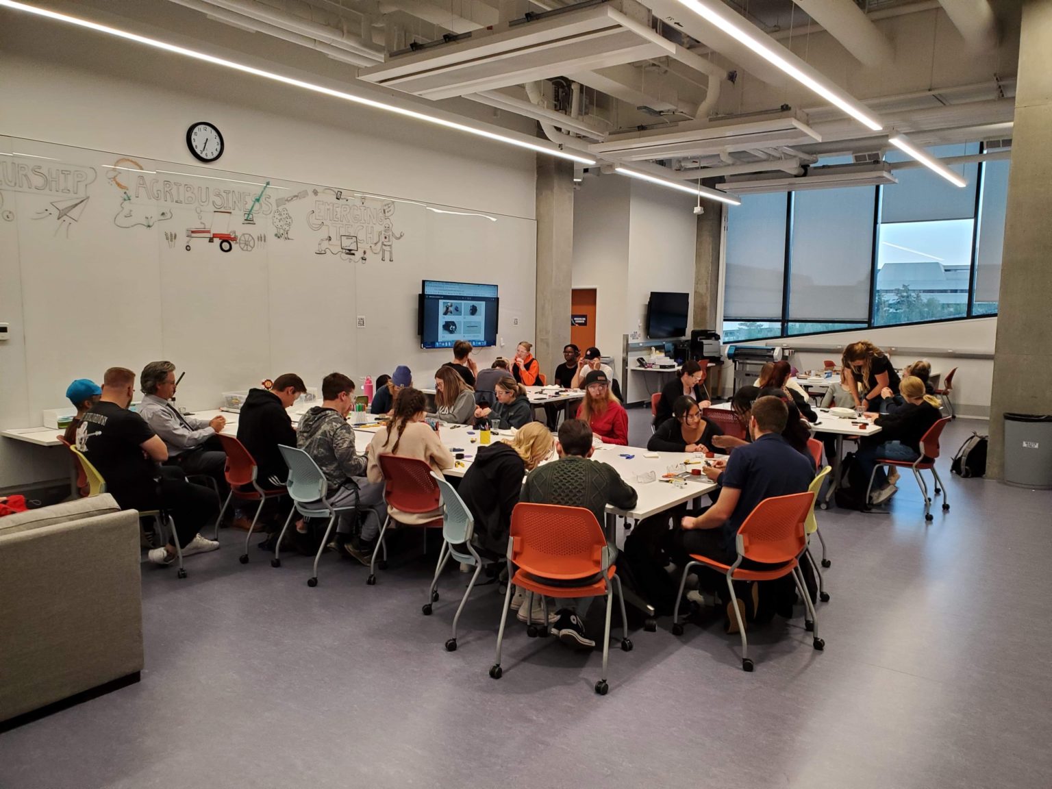A group of students building assistive technology in a classroom.