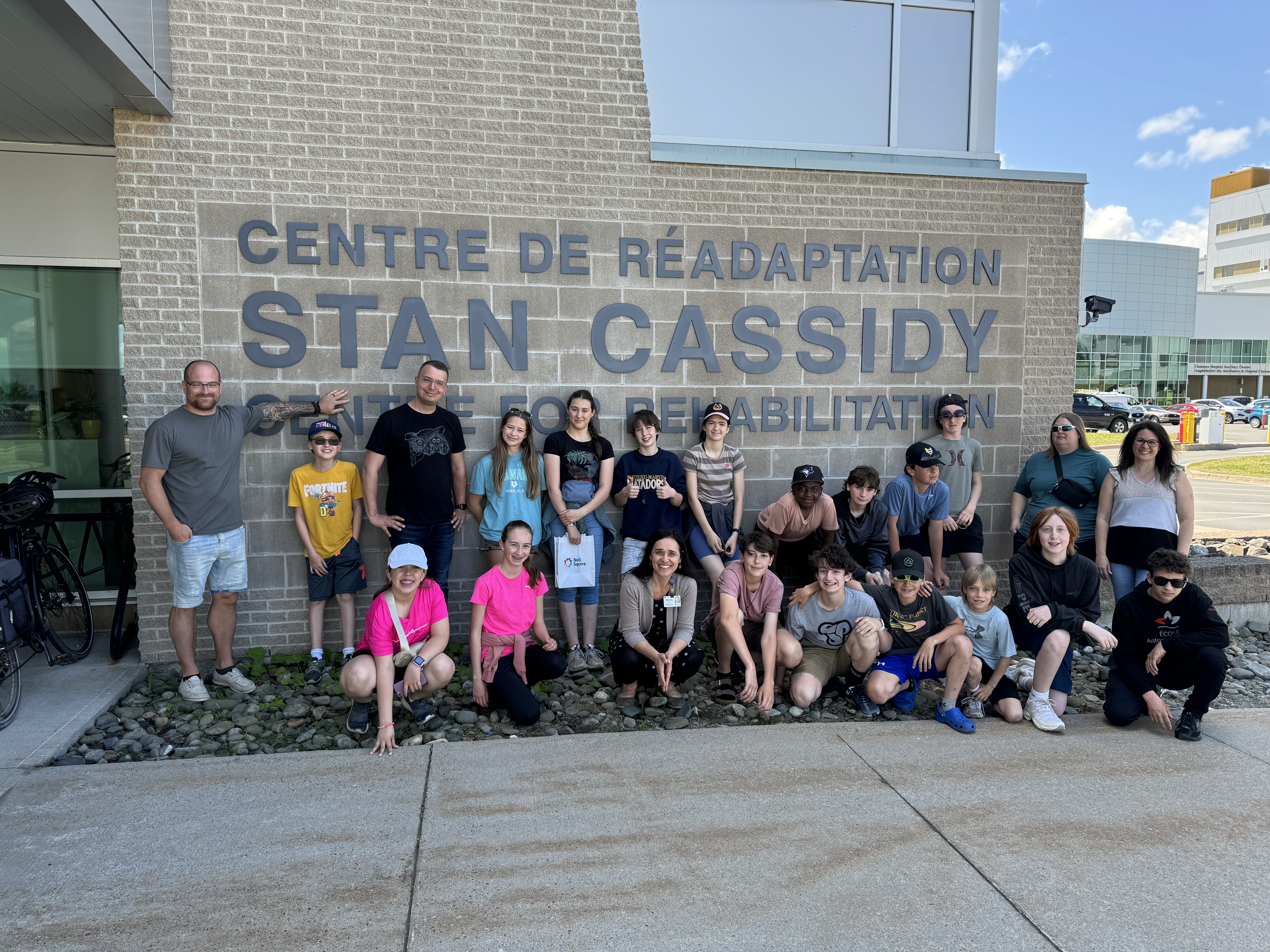 The students stand outside the Stan Cassidy Centre for Rehabilitation.