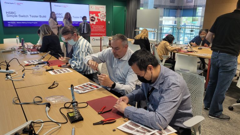 Participants building assistive tech at an HSBC event.